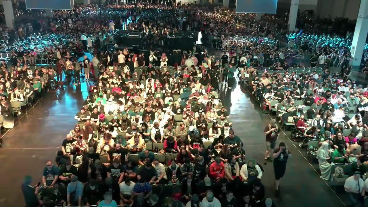 A large crowd attending a community event in a convention hall.
